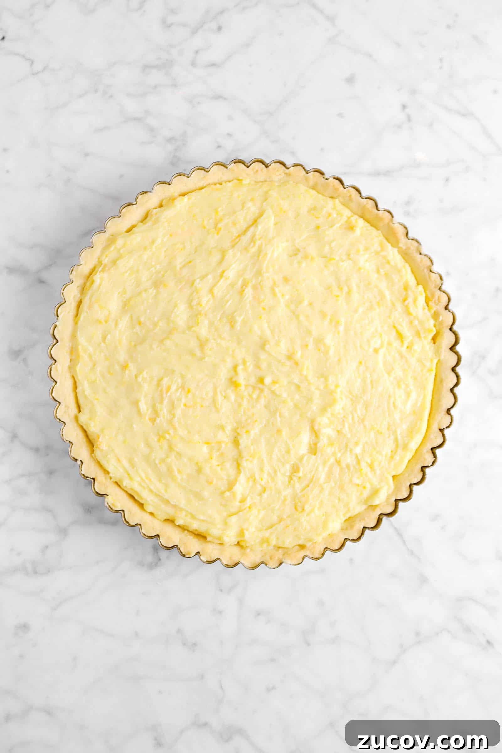 custard in tart shell on marble counter