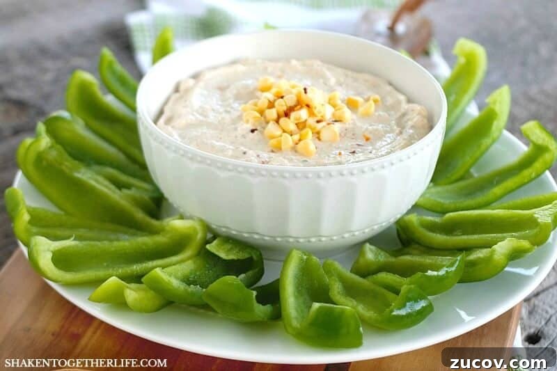 Creamy Chipotle Ranch Dip Recipe for Dipping & Spreading 2 Creamy Chipotle Ranch Dip in a bowl surrounded by sliced green bell peppers