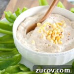 chipotle ranch dip in white bowl with sliced bell peppers