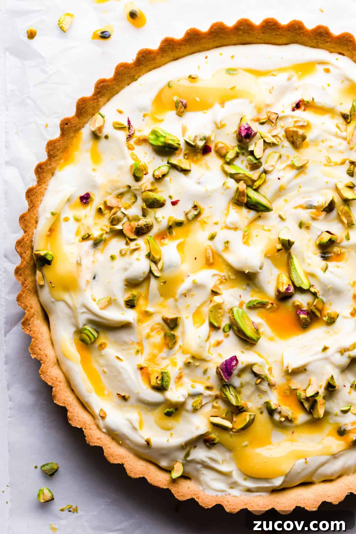 Zesty Lemon Mascarpone Tart Recipe for Creamy Citrus Dessert 2 top view super close up at a sweet tart with lemon curd, mascarpone and pistachios