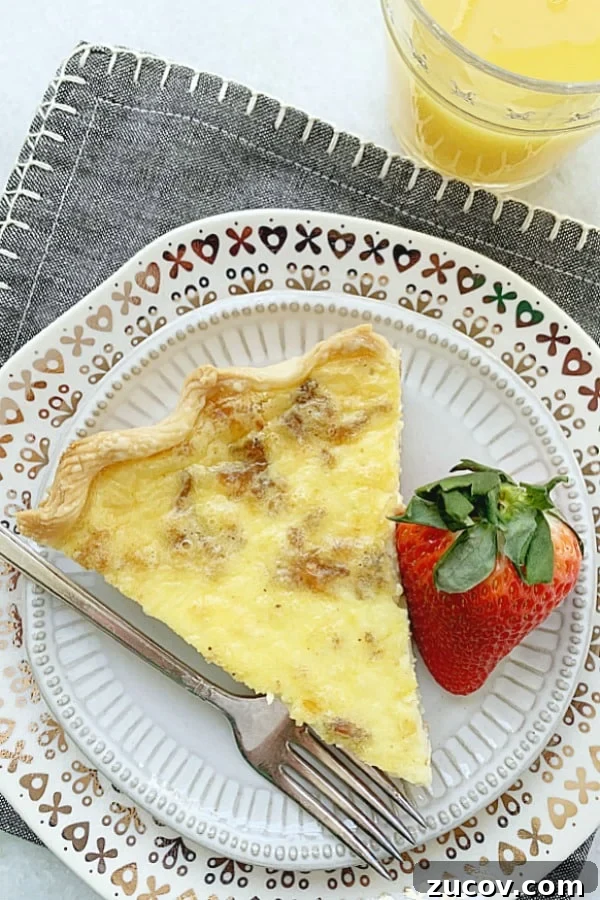 Classic Quiche Lorraine Recipe: Creamy Bacon and Gruyère Pie 2 overhead view of quiche slice on plate