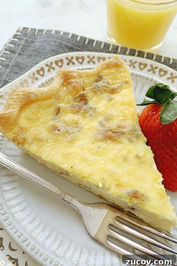 Classic Quiche Lorraine Recipe: Creamy Bacon and Gruyère Pie 5 slice of quiche lorraine on plate with strawberry