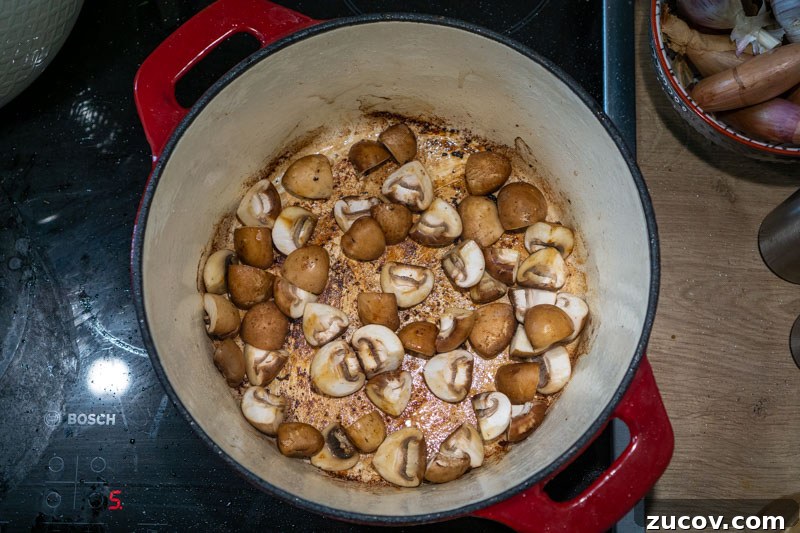 Classic Old-Fashioned Beef Stew Recipe (No Wine) 5 Adding the mushrooms to the pot
