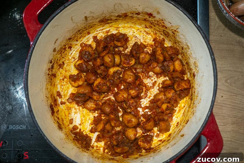 Classic Old-Fashioned Beef Stew Recipe (No Wine) 6 Stirring the tomato paste into your mushrooms and onions