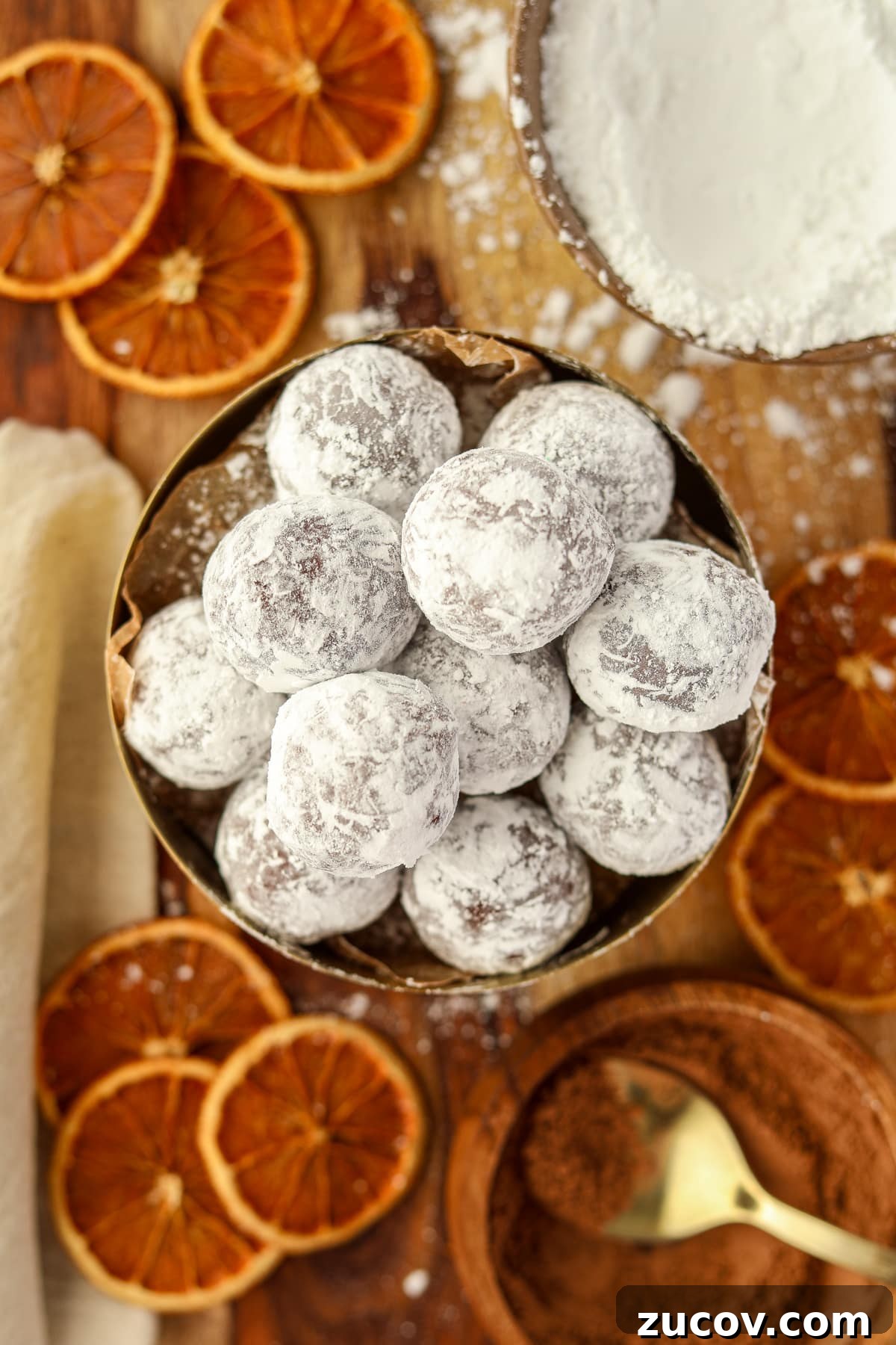 Decadent Chocolate Orange Truffles Recipe for Homemade Gifts 2 A bowl of chocolate truffles coated in powdered sugar.