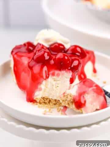 A slice of cheesecake topped with a cherry glaze.