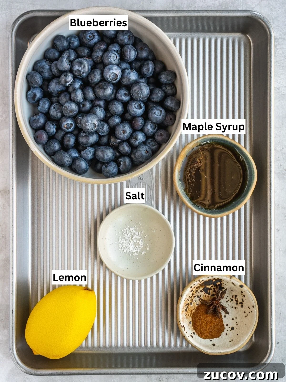 Maple Blueberry Compote Recipe for Pancakes and Yogurt 3 Blueberry Maple Compote recipe ingredients with individual labels on a metal tray.