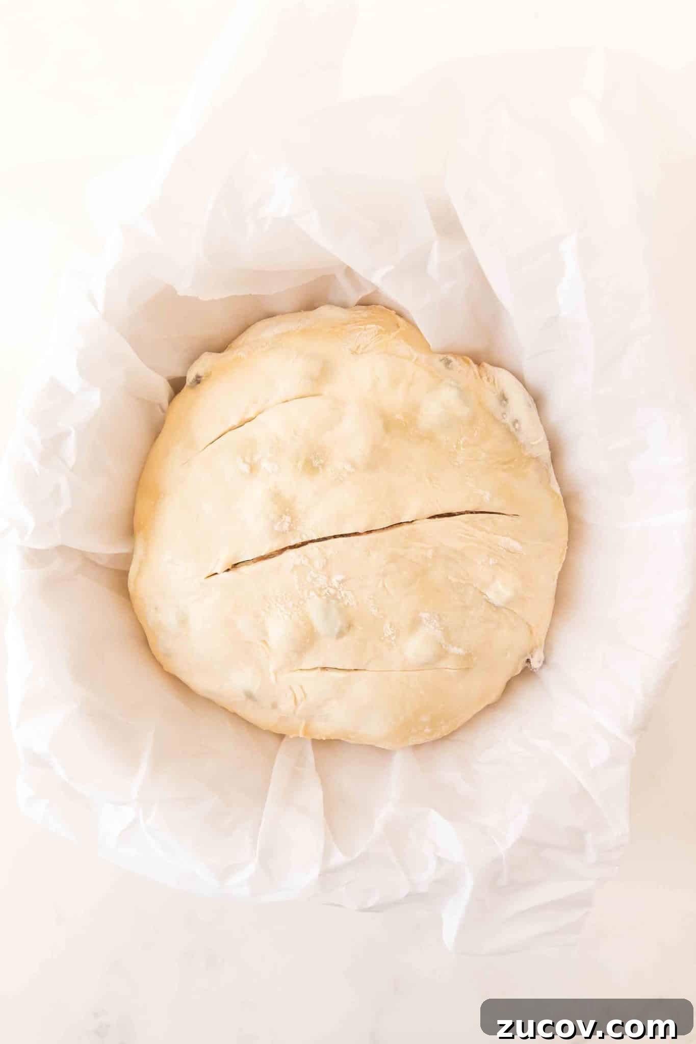 Sourdough Cinnamon Raisin Bread Recipe — Soft, Sweet & Spiced 14 Sourdough cinnamon raisin bread scored three times on top, in a Dutch oven ready to go into the oven. Hostess At Heart