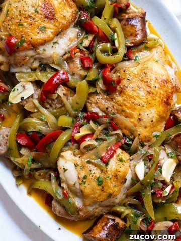 chicken scarpariello sitting on a plate with its braised juices