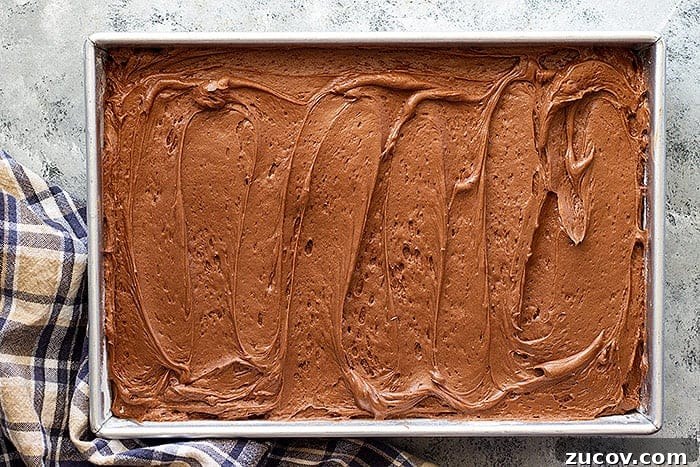 Decadent Chocolate Cream Cheese Frosting Recipe 4 overhead: cream cheese chocolate frosting spread on a cake