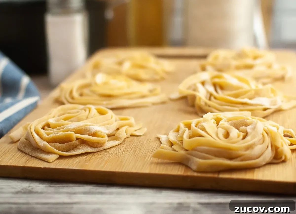 Homemade Gluten-Free Fettuccine Recipe for Perfect Pasta 9 Homemade pasta on a cutting board in nests.