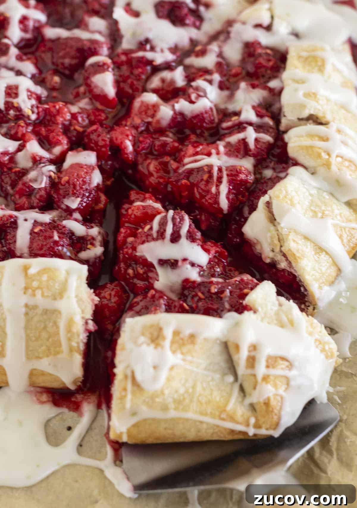 Fresh Raspberry Galette Recipe with Flaky Crust 8 Serving a piece of raspberry galette with lime glaze.