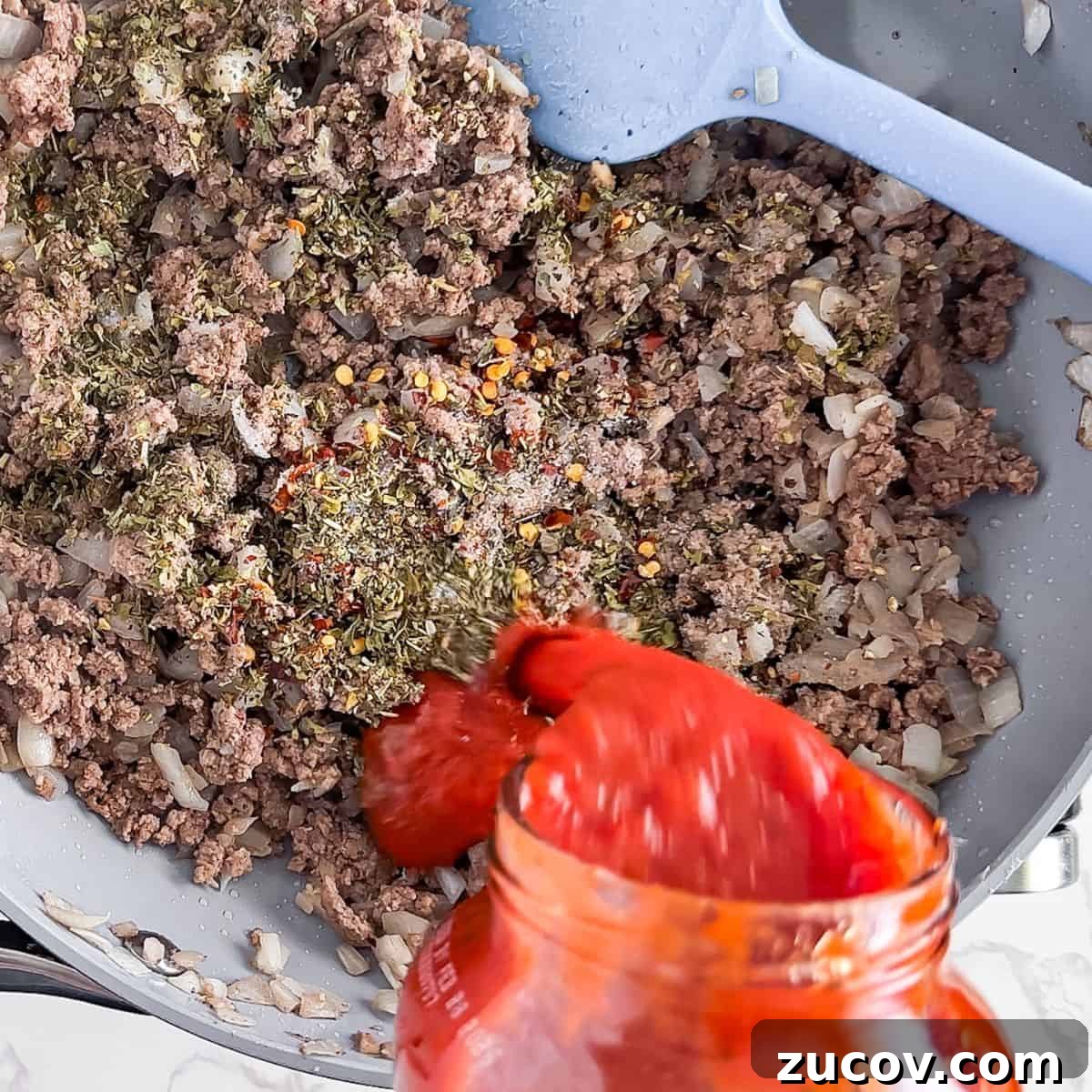 TikTok Spaghetti Recipe: Viral Creamy Pasta in 15 Minutes 5 Pouring in the 2 sauce with the cooked beef.