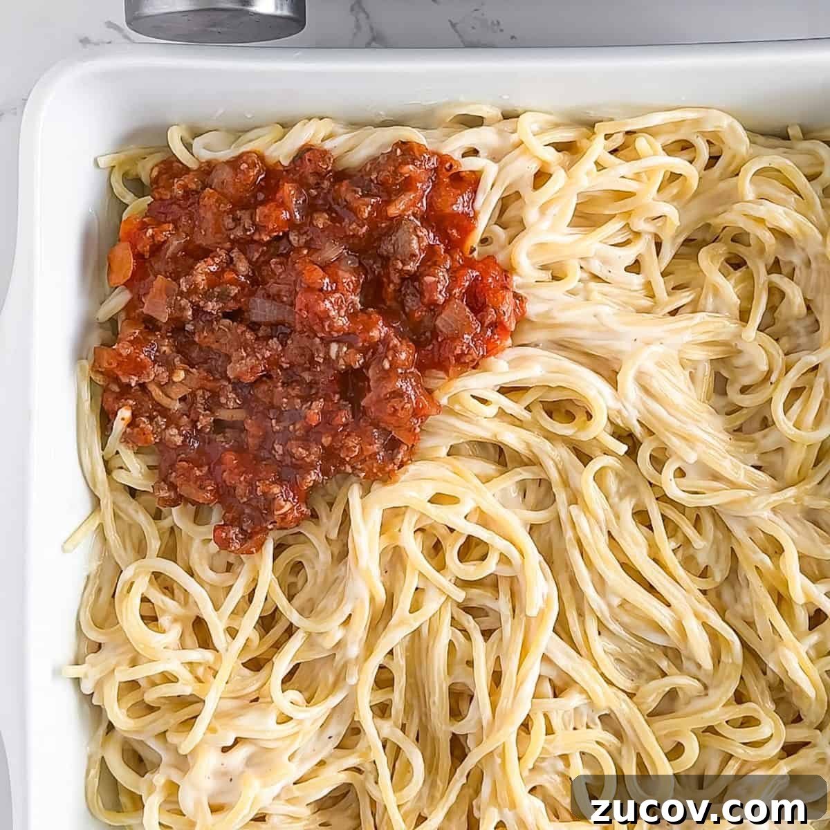 TikTok Spaghetti Recipe: Viral Creamy Pasta in 15 Minutes 6 Adding the sauce to the cooked spaghetti.