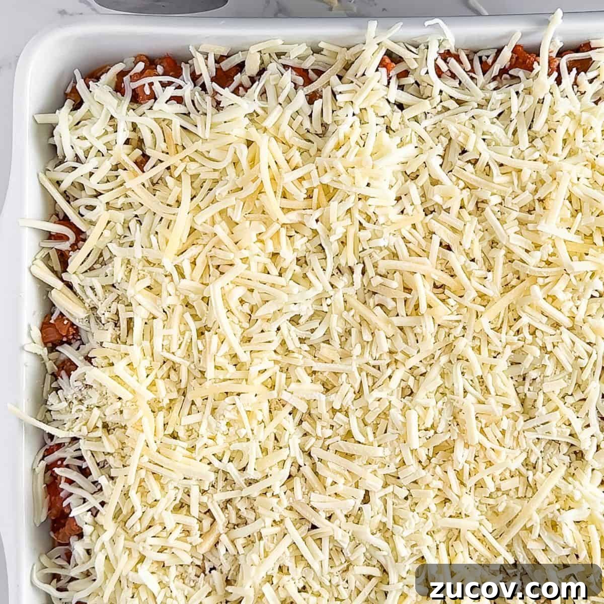 TikTok Spaghetti Recipe: Viral Creamy Pasta in 15 Minutes 7 Topping with mozzarella and parmesan cheese.