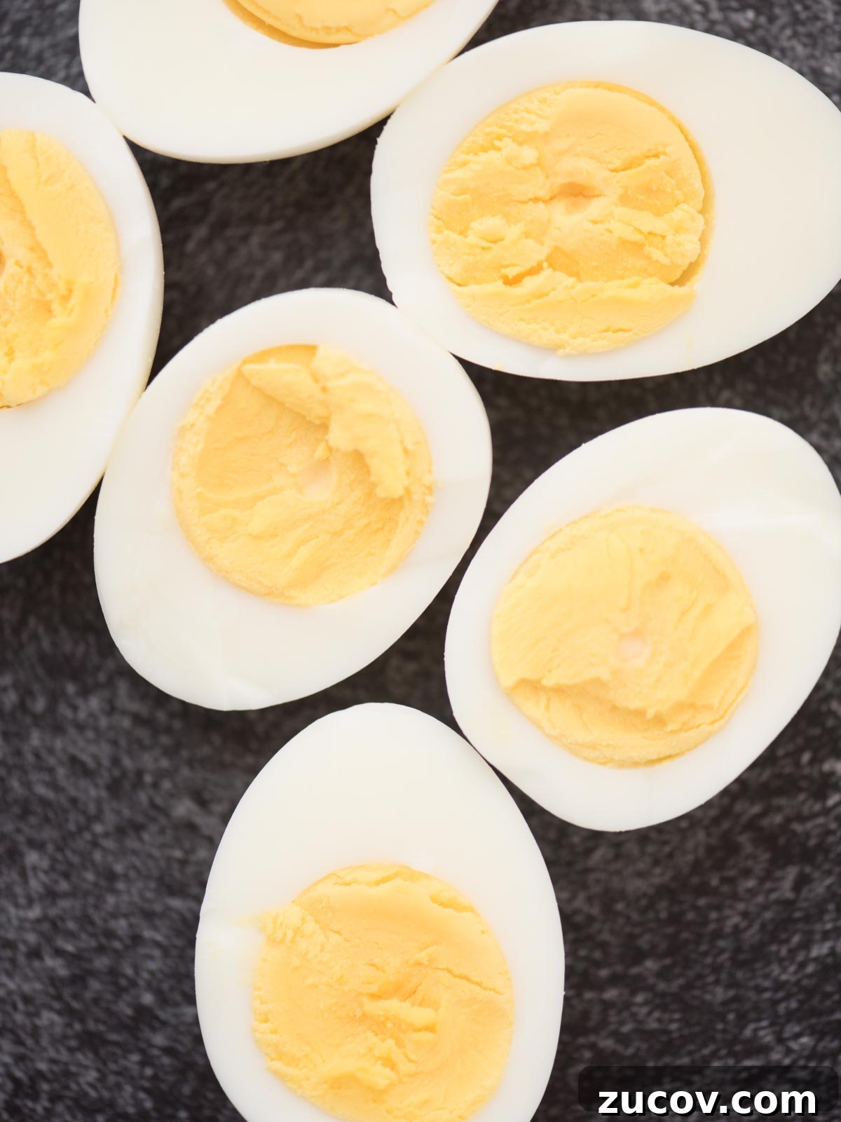 Perfect Hard-Boiled Eggs: Foolproof Method for Firm Whites & Creamy Yolks 6 Halved hard boiled eggs showing the yellow yolk inside.