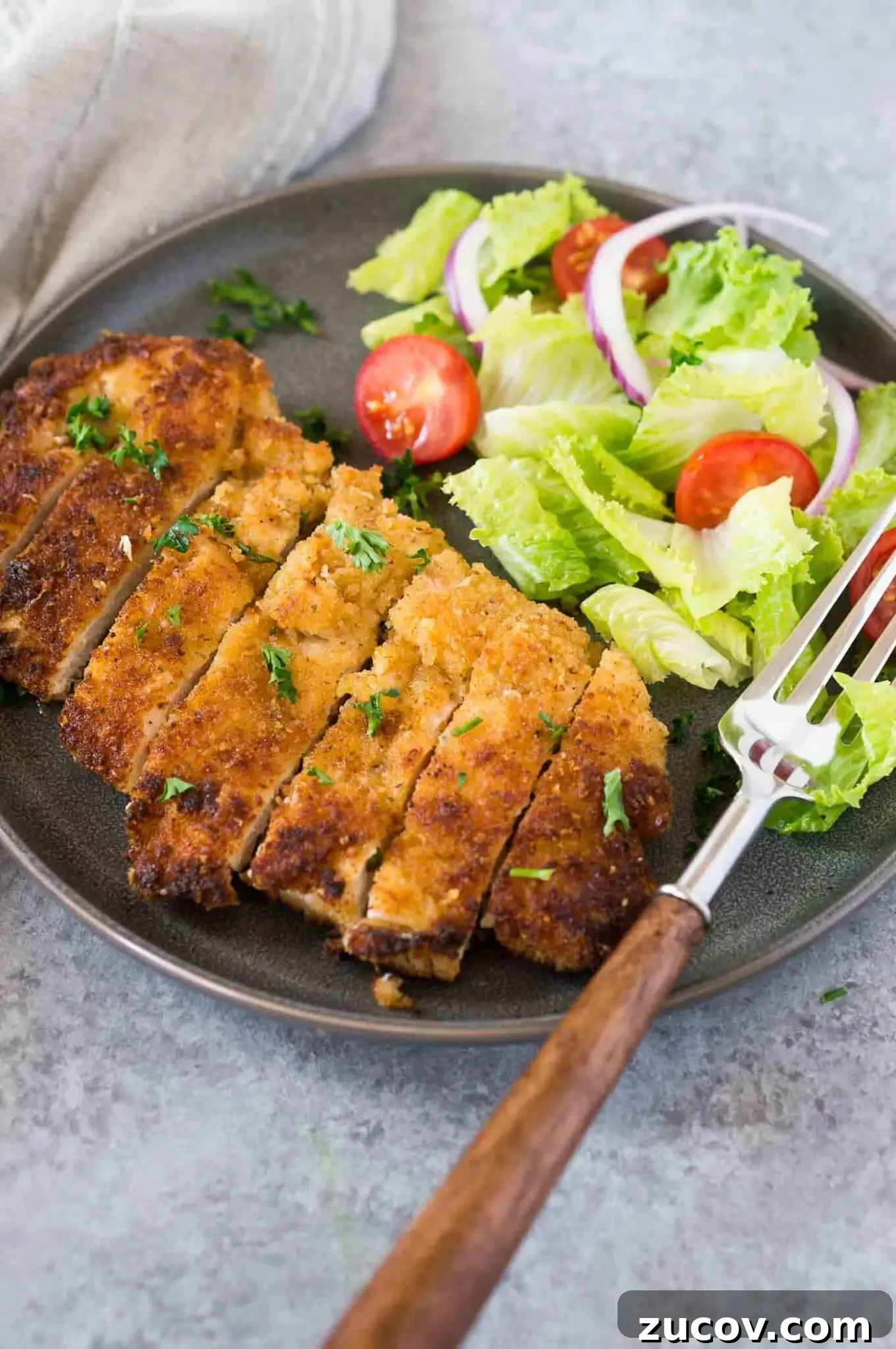 Crispy Chicken Milanese Recipe — Quick Italian-Style Cutlets 2 chicken milanese and a salad on a plate