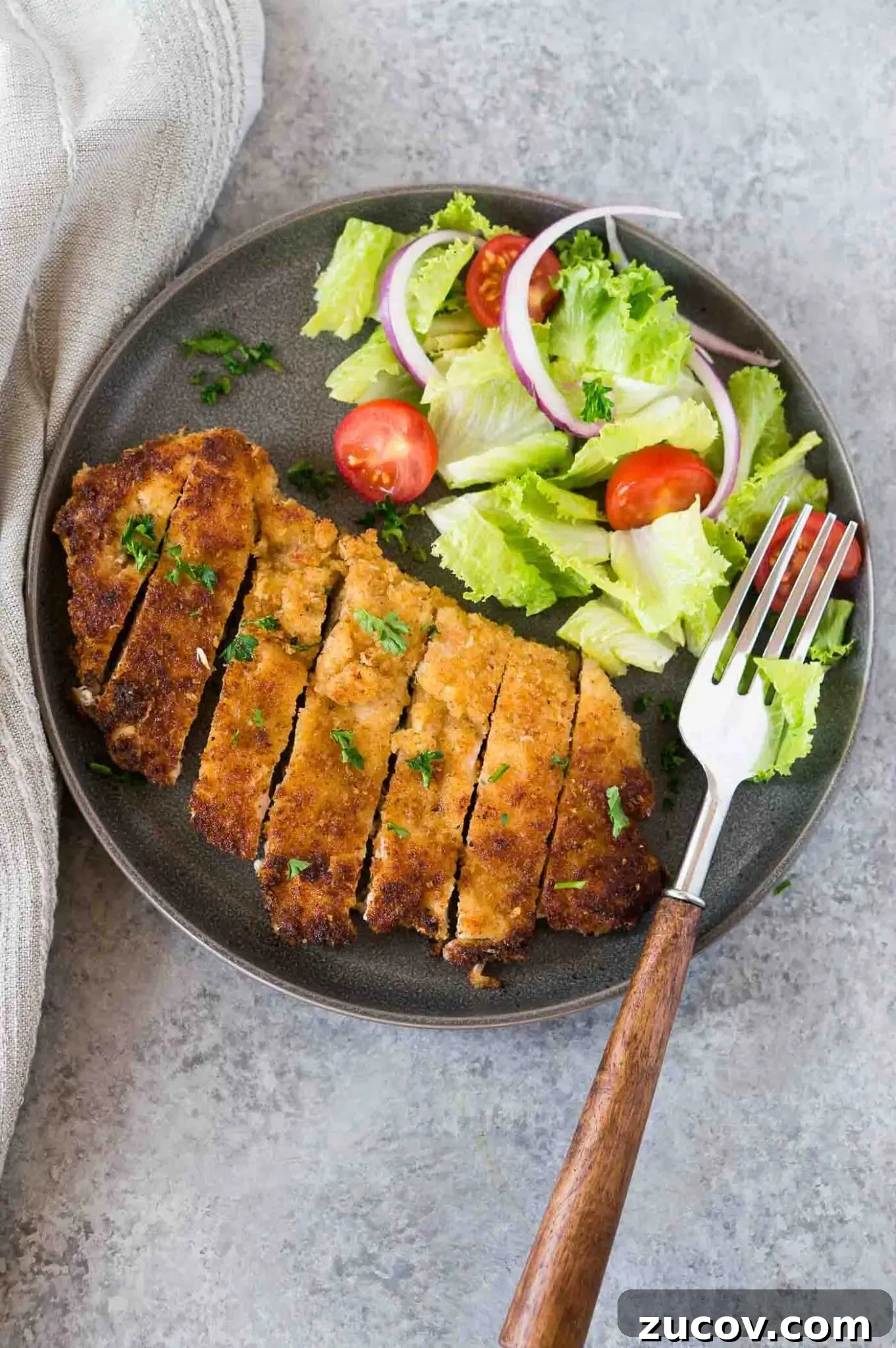 Crispy Chicken Milanese Recipe — Quick Italian-Style Cutlets 6 breaded chicken cutlet and a light salad on a plate