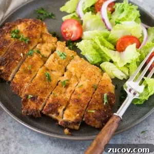 Crispy Chicken Milanese Recipe — Quick Italian-Style Cutlets 7 chicken milanese and a salad on a plate