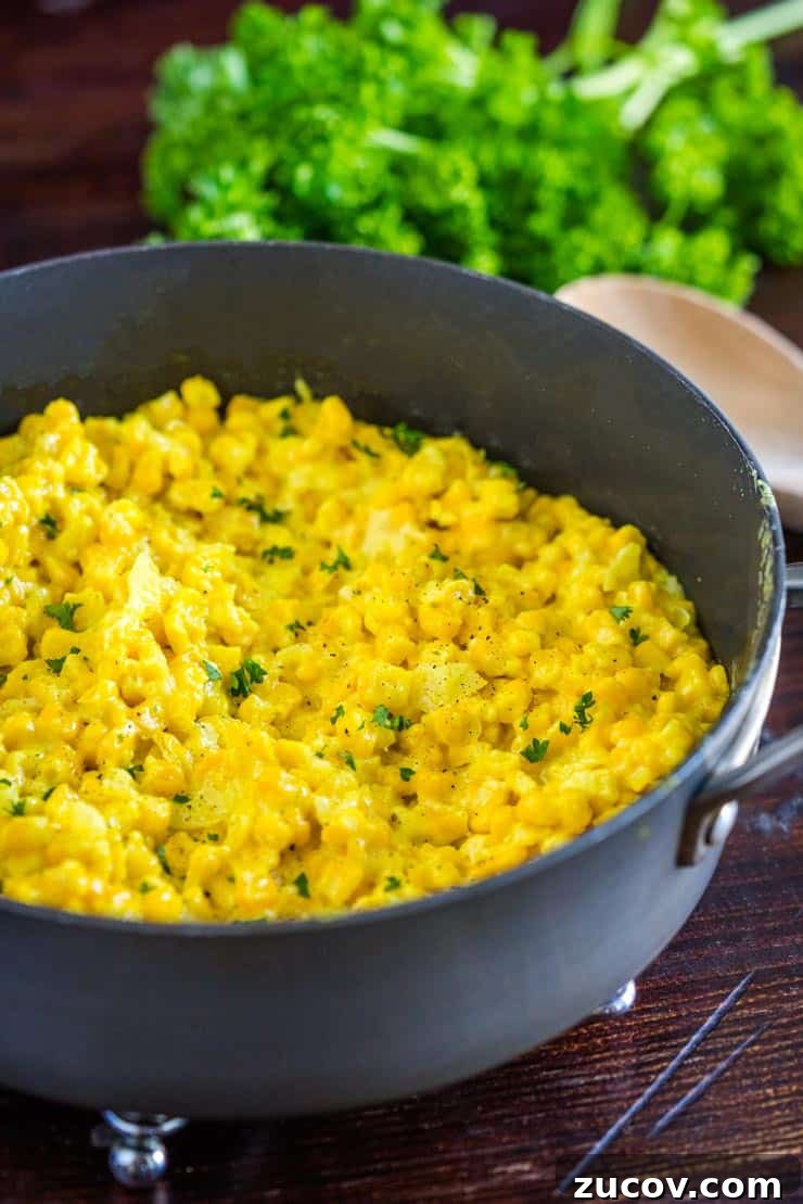 Creamy Homemade Corn Recipe for Comforting Side Dish 6 A pan of creamy homemade creamed corn with parsley on top