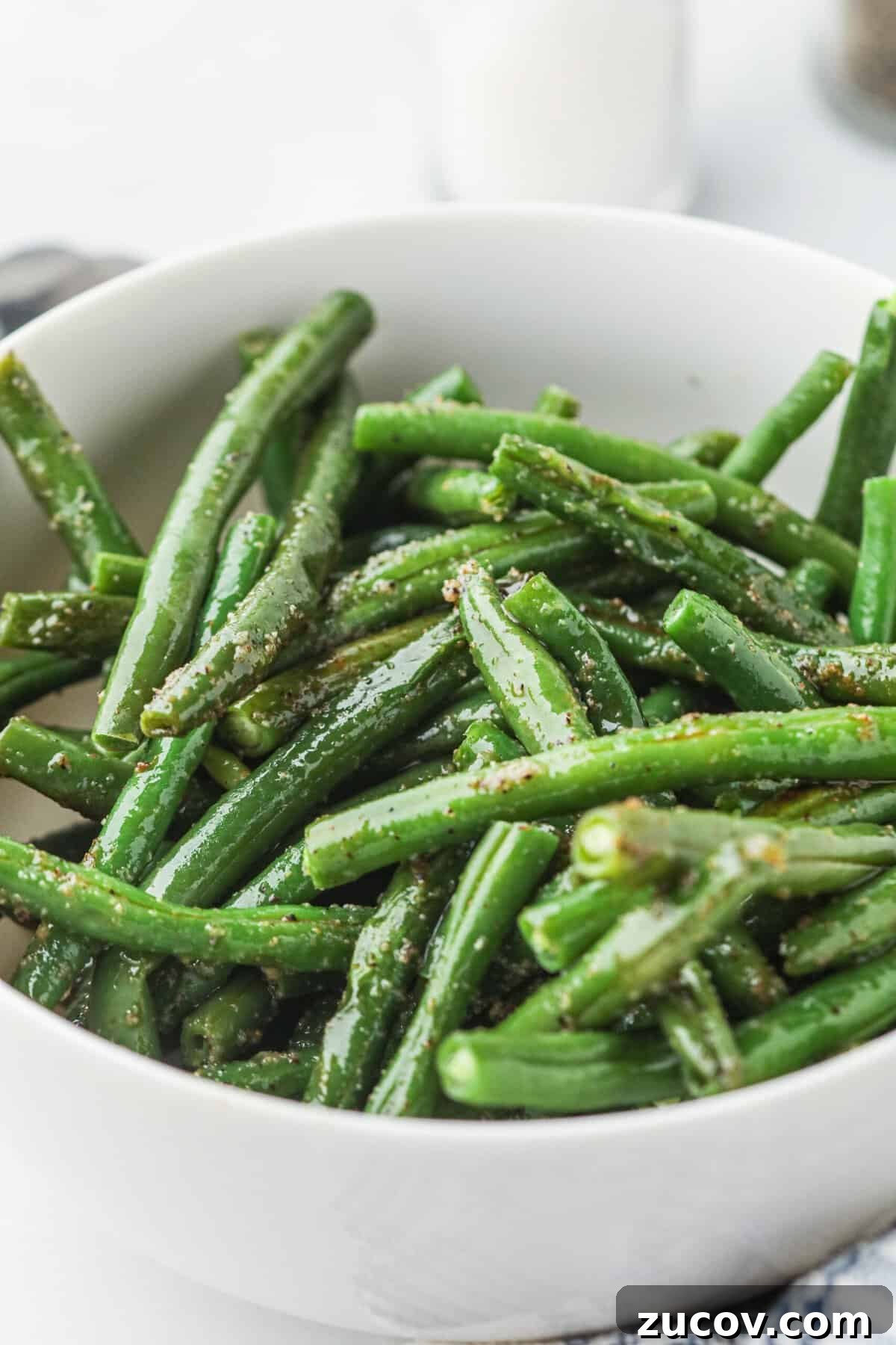 Grilled Green Beans in Foil Packets: Simple Camping Side Dish 2 White bowl with grilled green beans in it.