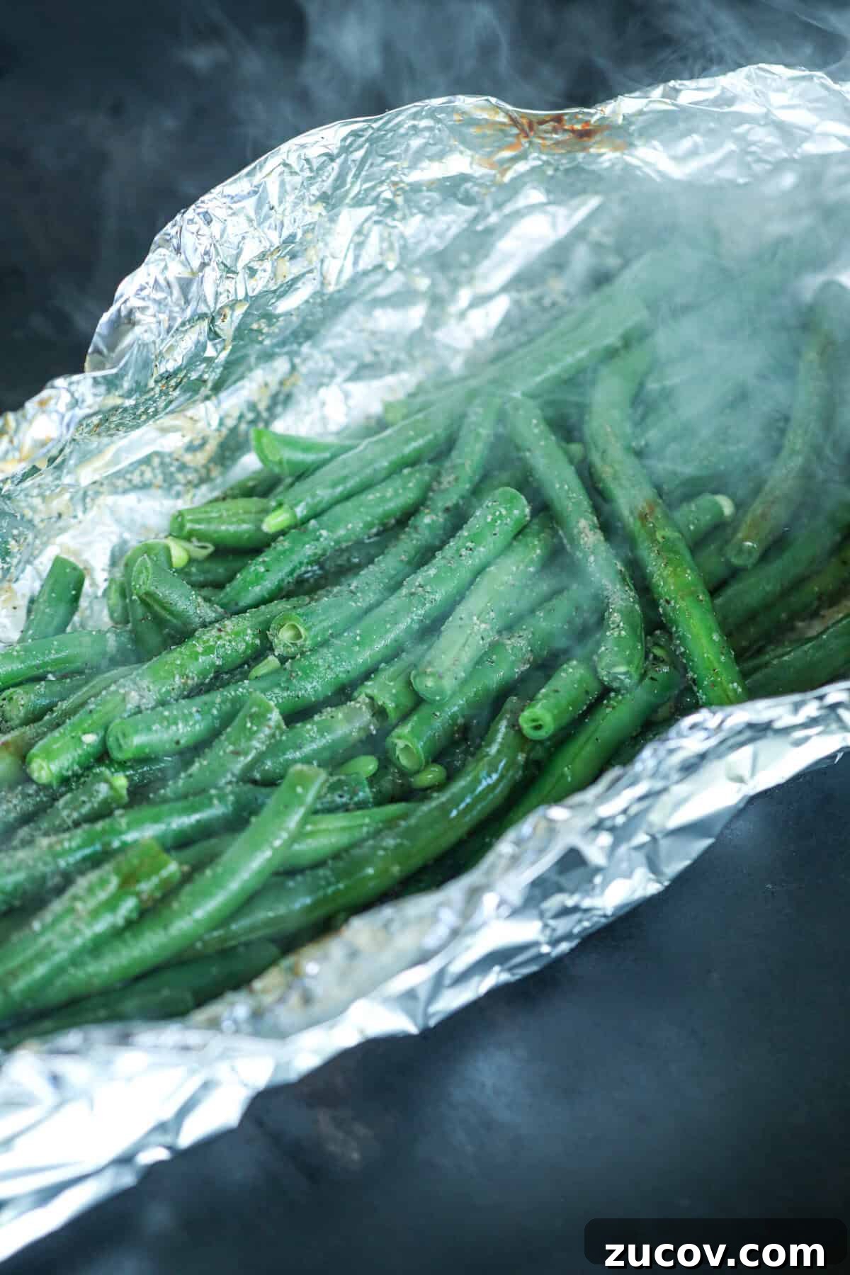 Grilled Green Beans in Foil Packets: Simple Camping Side Dish 5 Close up of cooked green beans in foil on grill