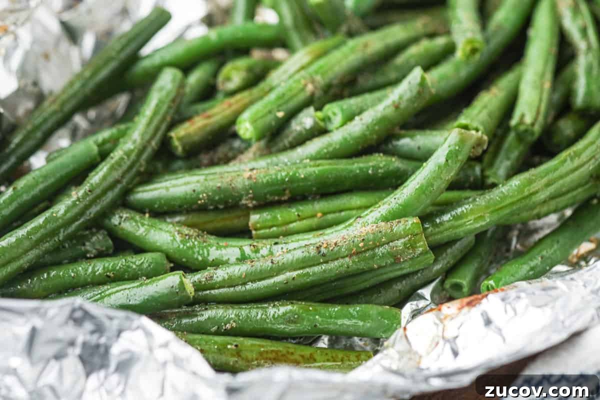 Grilled Green Beans in Foil Packets: Simple Camping Side Dish 6 Close up of cooked green beans in foil.
