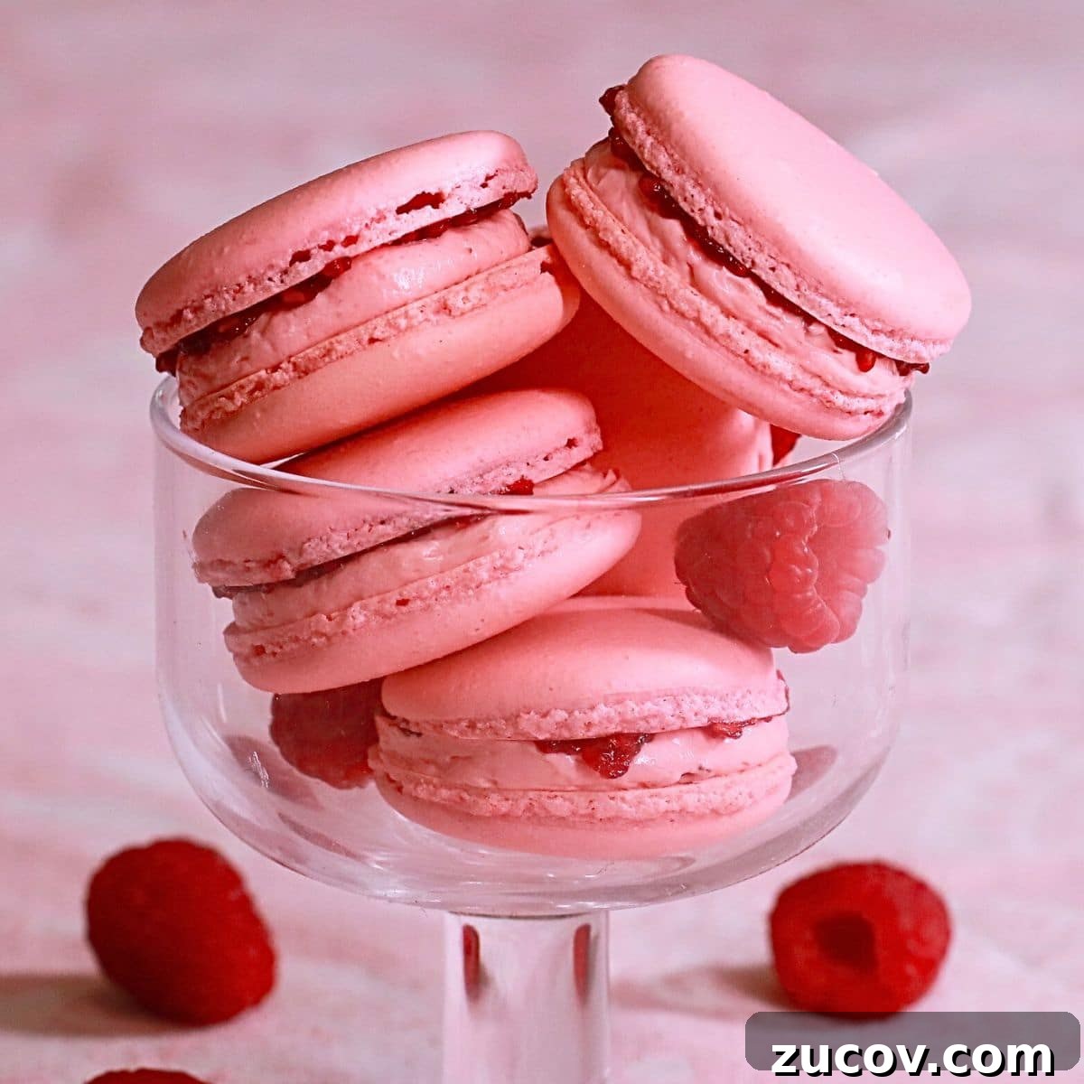 Raspberry Macarons Recipe: Light, Tangy French Cookies 5 homemade best raspberry macarons in a glass cup.