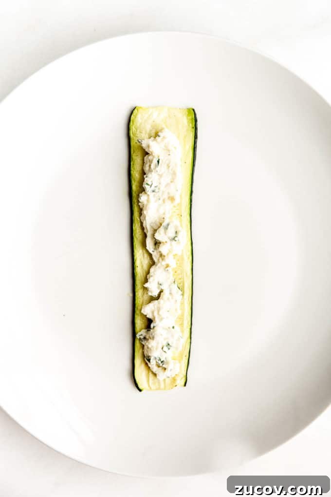 Ricotta-Stuffed Zucchini Roll-Ups with Tomato Basil Sauce 7 A slice of zucchini with ricotta spread in the centre
