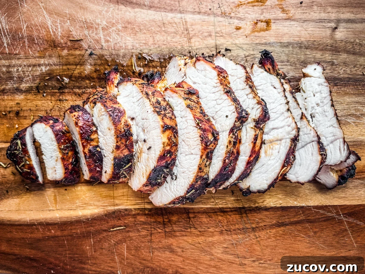 Crispy Juicy Air Fryer Turkey Breast Recipe 5 Air fryer turkey breast sliced on a cutting board.