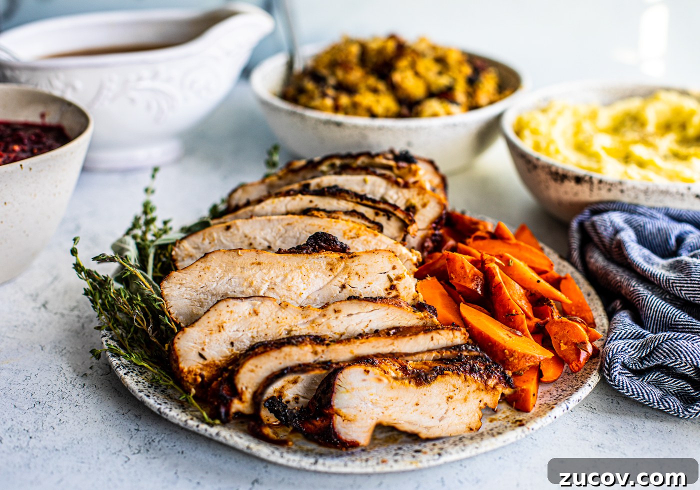 Crispy Juicy Air Fryer Turkey Breast Recipe 6 Close up side shot of sliced turkey breast on serving platter.