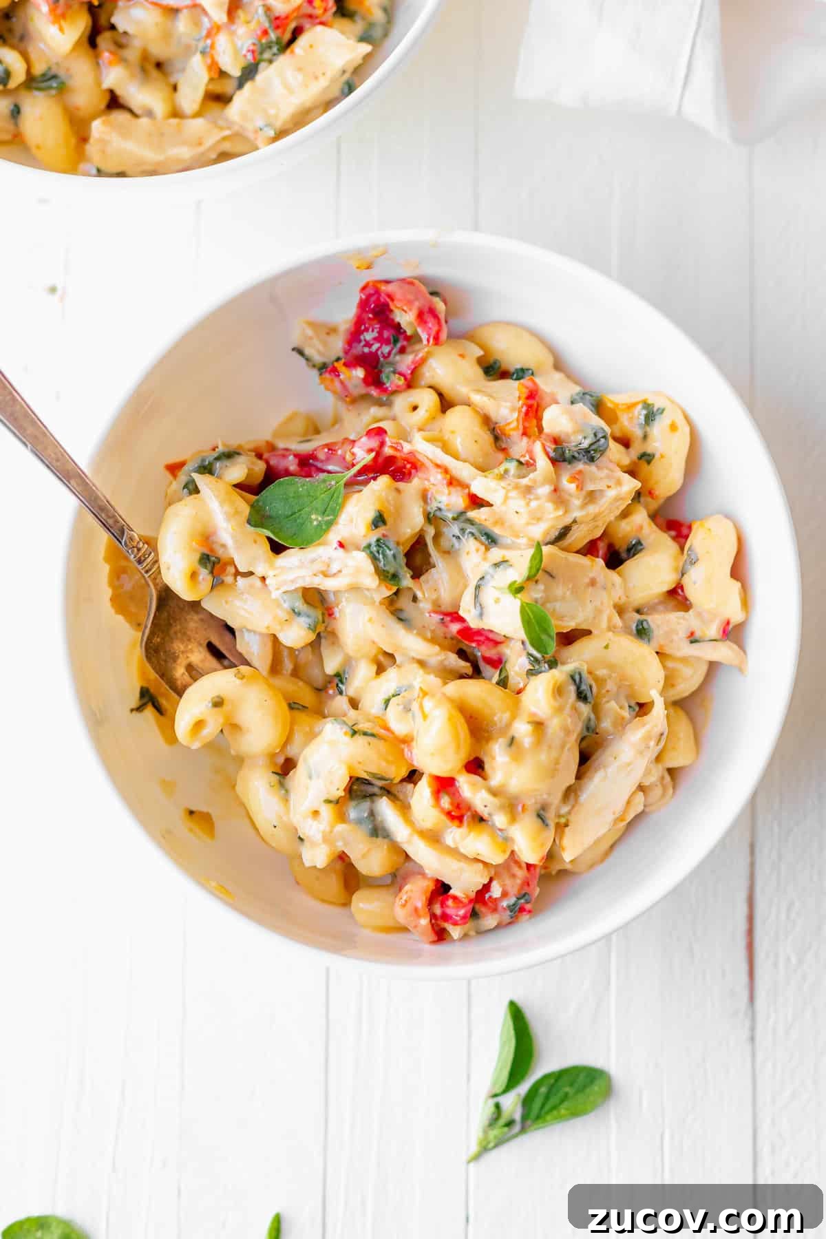 Tuscan Chicken Mac and Cheese Tuscan chicken mac and cheese in a bowl.
