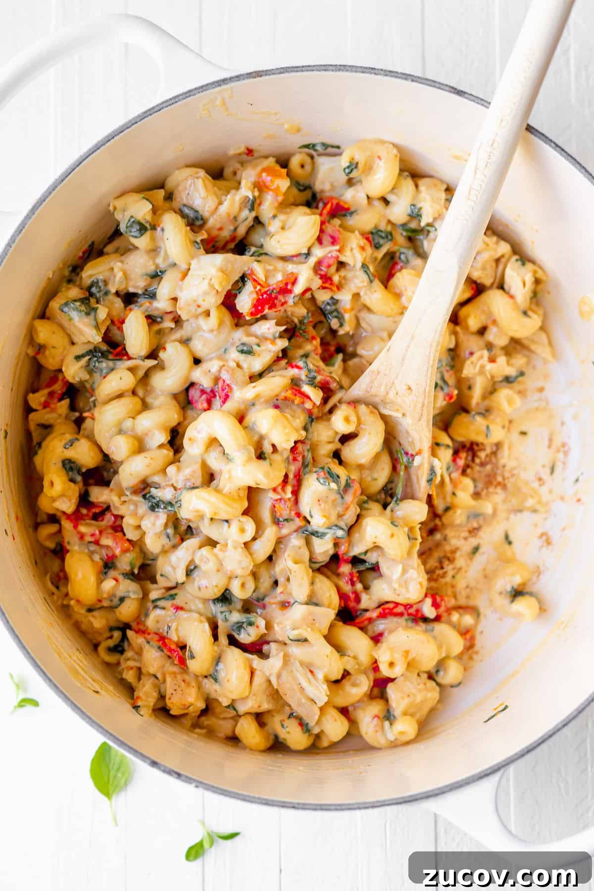 Tuscan Chicken Mac and Cheese All the tuscan chicken mac and cheese ingredients mixed together and ready to be served.