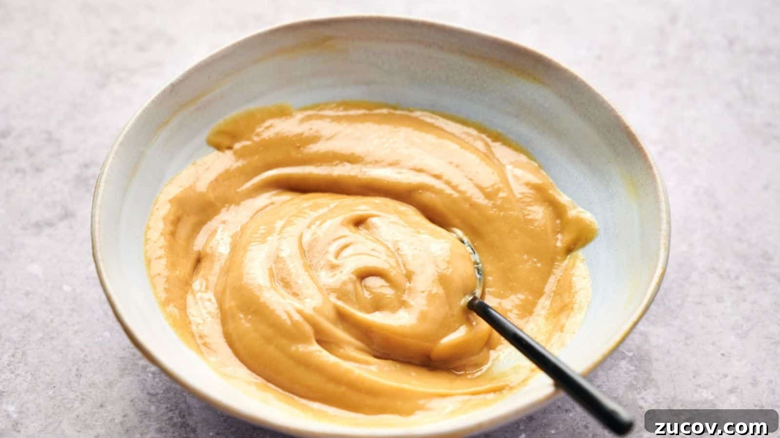 21 Summer Budget Meals That Make Takeout Obsolete 12 A bowl of smooth, creamy peanut butter with a hint of Chick-fil-A sauce and a spoon inside.