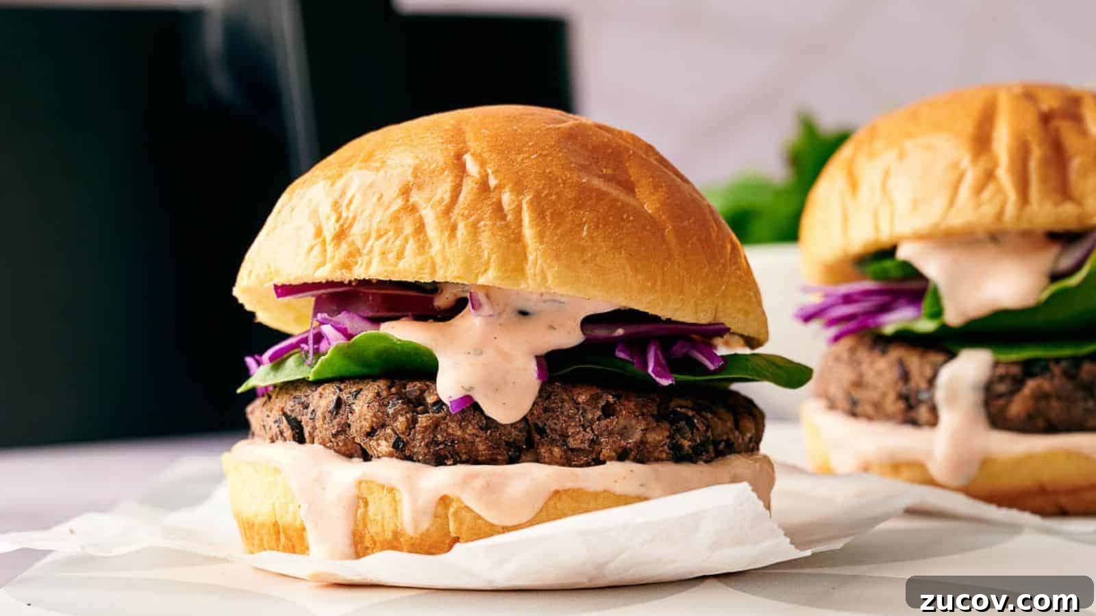 21 Summer Budget Meals That Make Takeout Obsolete 10 A black bean burger in a burger bap with relish oozing out over it.