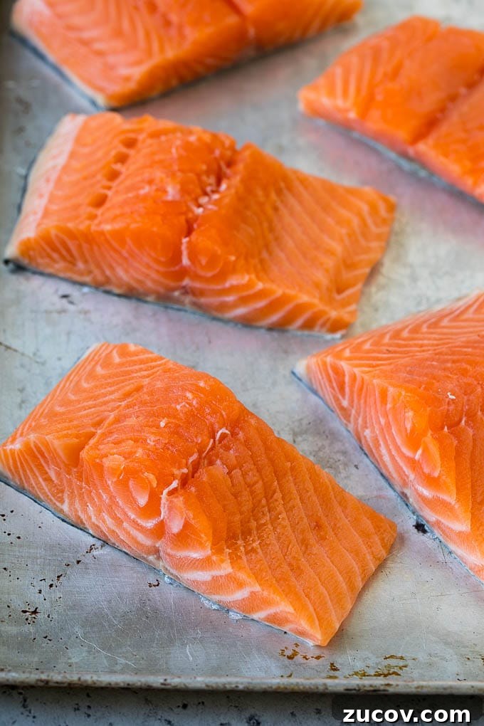 Raw salmon fillets on a sheet pan Raw salmon fillets on a sheet pan.