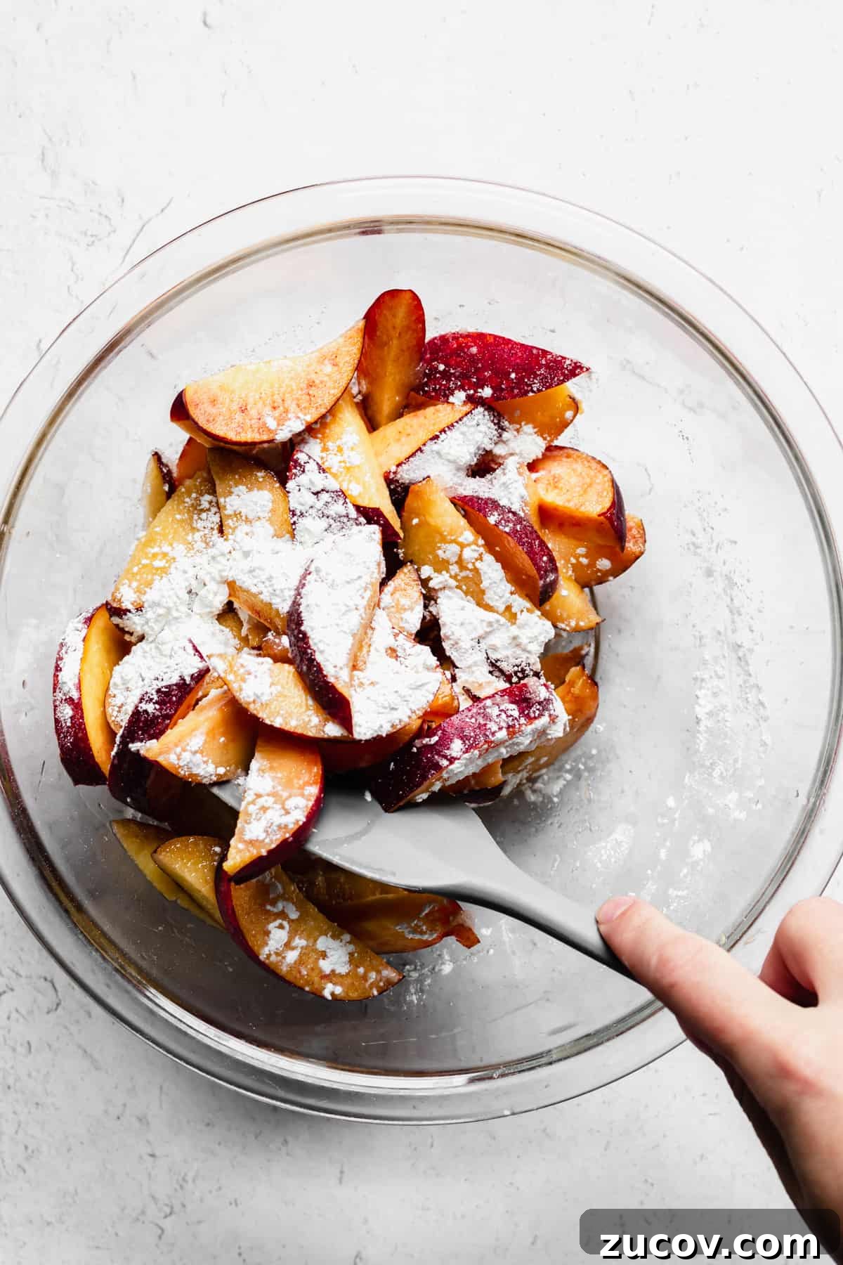 Peach and Almond Frangipane Galette Recipe 6 Fresh sliced peaches are getting mixed with sugar and cornstarch.