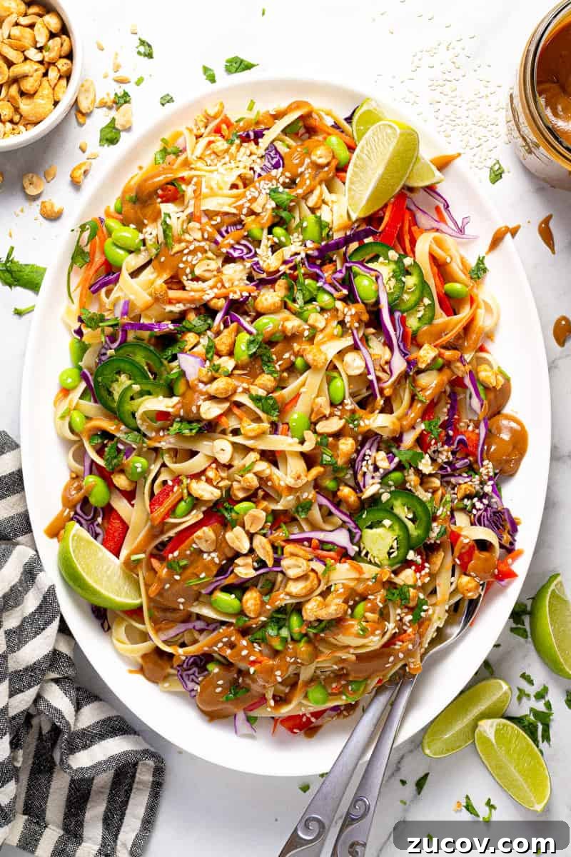 Chilled Vegan Peanut Noodle Salad with Crunchy Veggies 2 Large white platter filled with vegan peanut pasta salad garnished with fresh cilantro