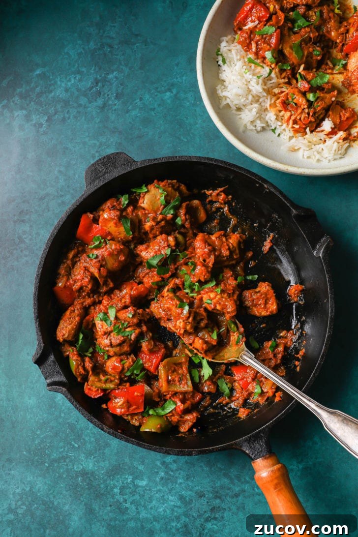 Authentic Chicken Jalfrezi Recipe: Spicy Tangy Curry at Home 11 Half-eaten chicken jalfrezi in a black skillet