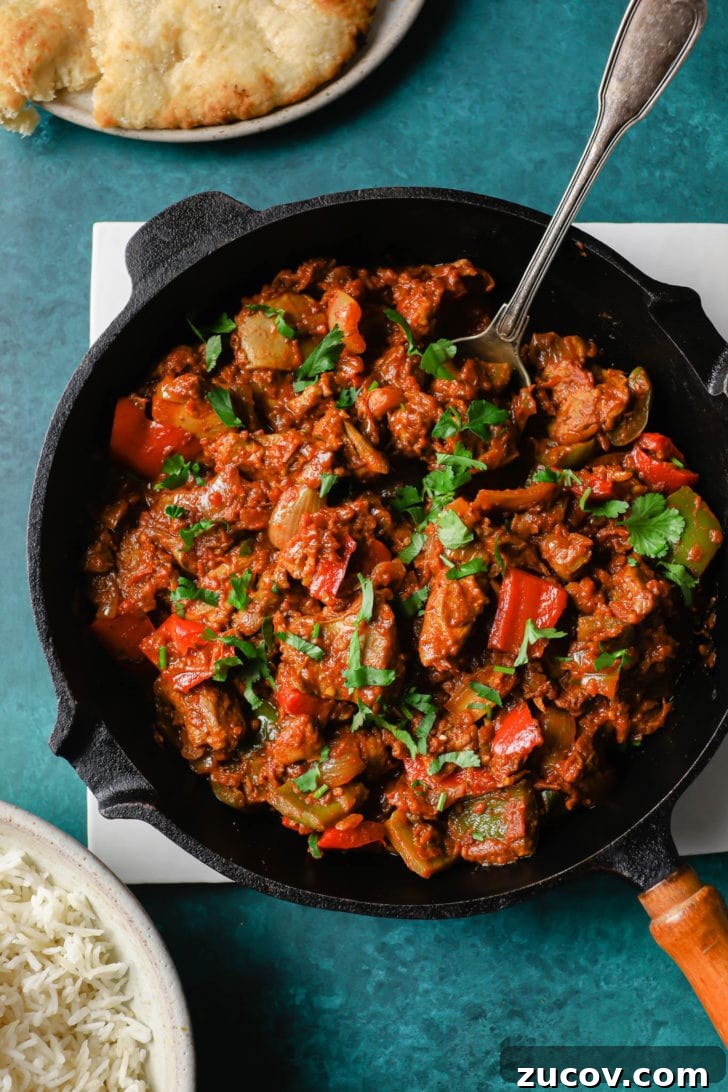 Authentic Chicken Jalfrezi Recipe: Spicy Tangy Curry at Home 3 Chicken Jalfrezi in a black skillet with a silver spoon