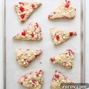 White Chocolate and Raspberry Scones Recipe for Brunch 11 Cranberry almond scones on a baking sheet.