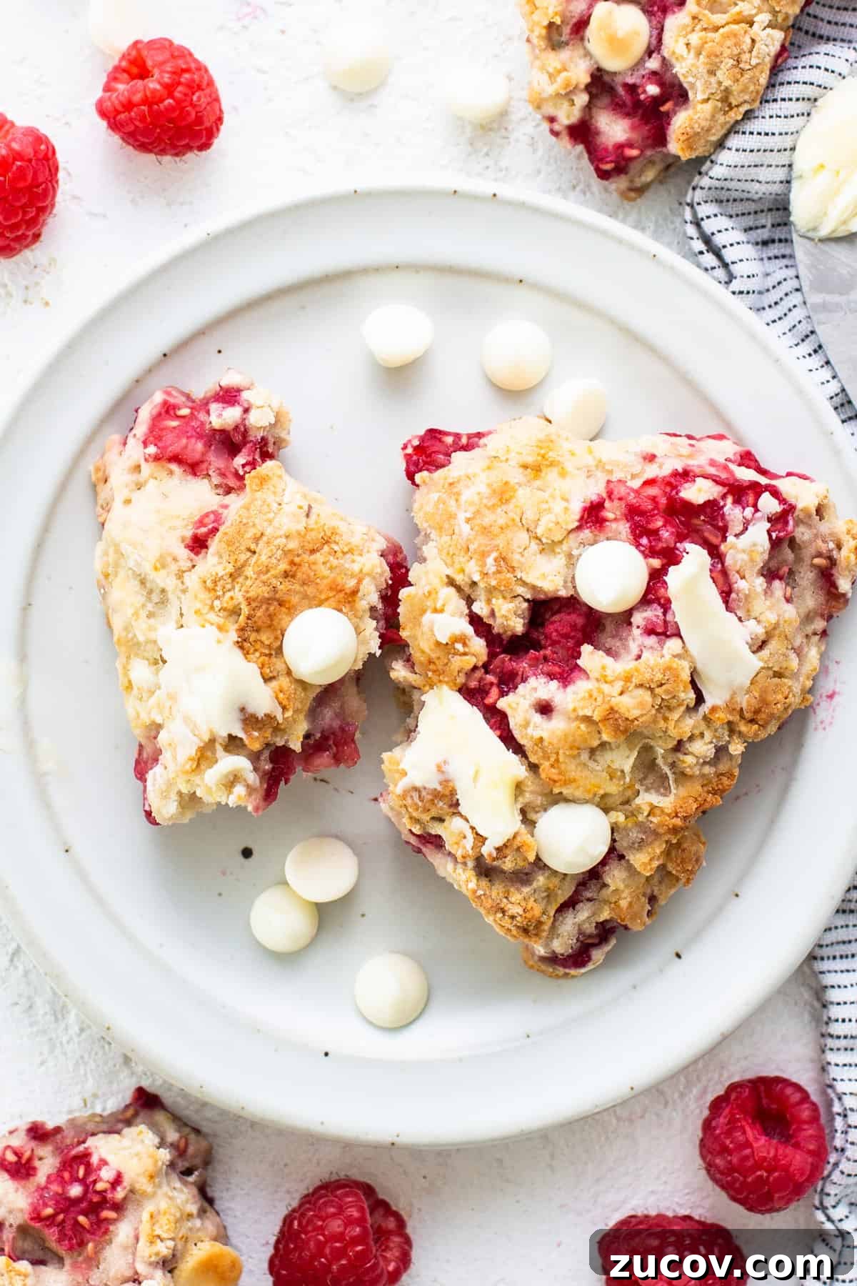 White Chocolate and Raspberry Scones Recipe for Brunch 6 Raspberries and white chocolate scones on a plate.
