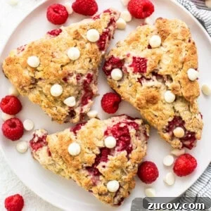 White Chocolate and Raspberry Scones Recipe for Brunch 7 Raspberry and white chocolate scones on a plate.