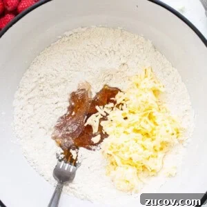 White Chocolate and Raspberry Scones Recipe for Brunch 8 A bowl filled with ingredients for a cake.