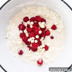White Chocolate and Raspberry Scones Recipe for Brunch 9 A bowl with raspberries and white chocolate in it.