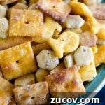 close up of various snack crackers with seasoning in a bowl