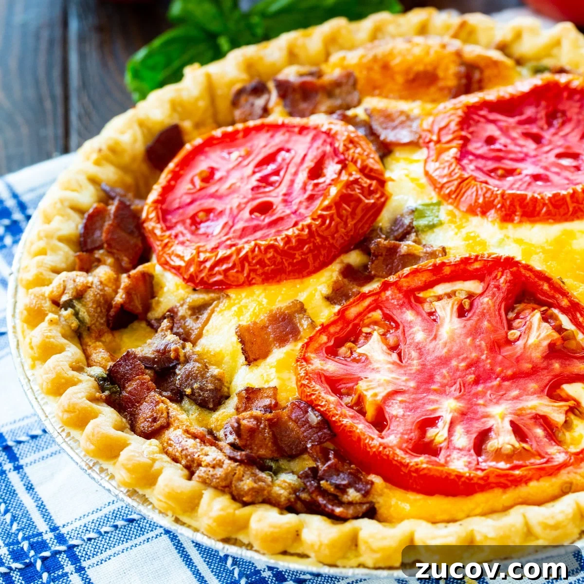 Savory Tomato and Bacon Pie Recipe for Summer Gatherings 2 Whole Tomato Pie with Bacon in pie pan.