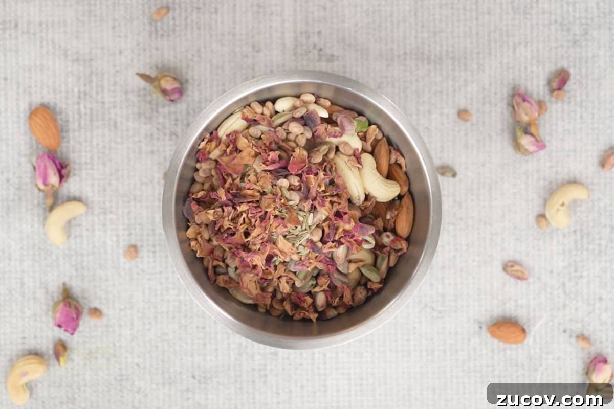 Masala Doodh (Spiced Indian Milk) Recipe — Creamy Cardamom Saffron Milk 3 Almonds, cashew nuts, pistachios, chironji, fennel seeds and rose petals added to a blender.