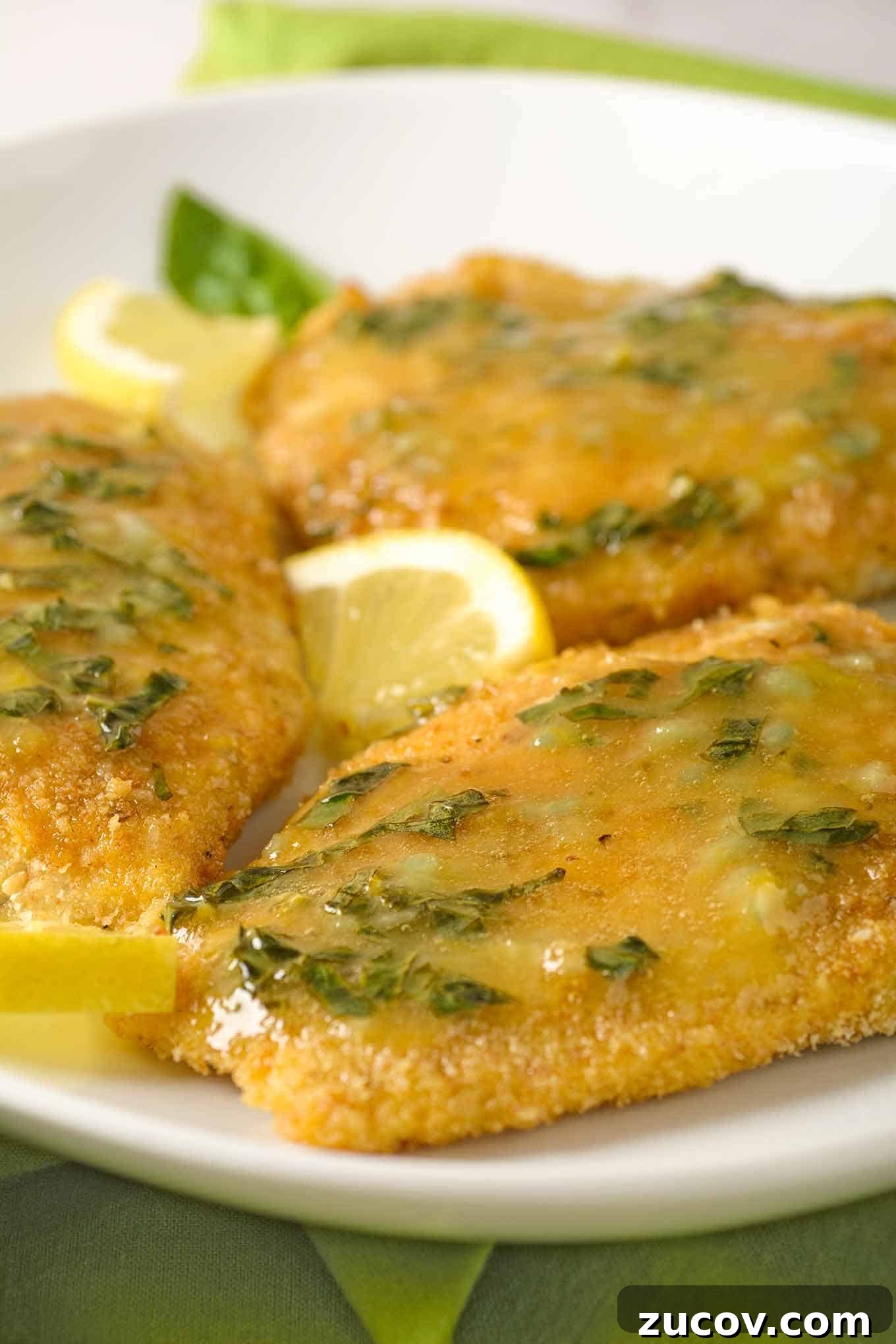 Lemon Basil Butter Oven-Fried Fish Recipe 3 A serving of crumb-coated, oven-fried fish fillets topped with lemon basil butter and garnished with lemon.