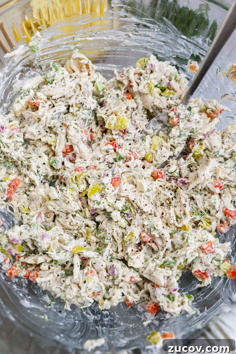 Greek-Style Feta Chicken Salad with Lemon-Dill Dressing 5 A large clear mixing bowl filled with freshly made feta chicken salad